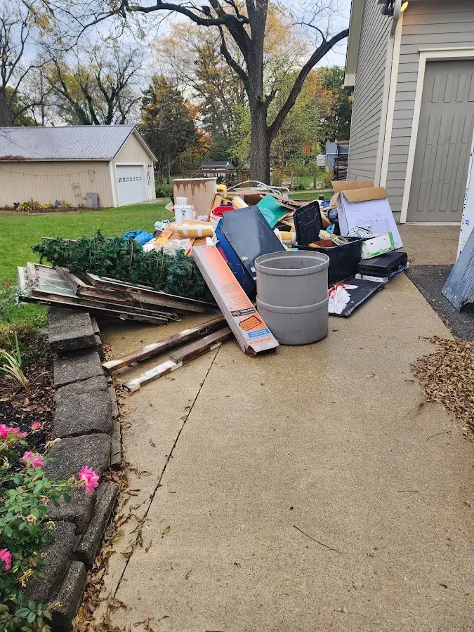 Dumpster being loaded with debris for Demolition Dumpster Rental in Wellsville